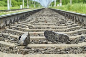 Accident on railway. Rubber boots lying on railway track                              