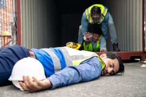 Handsome engineer lies unconscious on the ground after exposure to life-threatening chemicals.