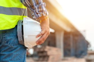 worker or civil engineer holding safety white helmet